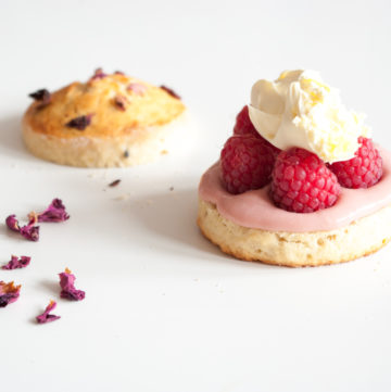 Raspberry Scones with Clotted Cream – Tender, moist, lightly sweet English scones, piled with clotted cream and tart fresh raspberries. A gorgeous summer dessert recipe. By @deliciouscratch | deliciousfromscratch.com