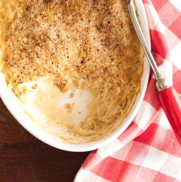 Shredded Potato Casserole with Cheese – A luxurious, creamy side dish with soft strands of grated potato in a garlic and Parmesan sauce. An elegant gratin that would be great for a Sunday roast or Christmas dinner. By @deliciouscratch | deliciousfromscratch.com