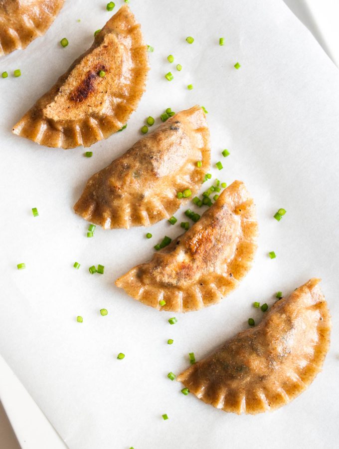 Vegan Potstickers with Tofu – Soft and crispy Chinese dumplings with an umami tofu and mushroom filling. Uses homemade wholegrain dumpling dough. This vegan gyoza recipe is super healthy and incredibly satisfying. Great vegan appetizer. By @deliciouscratch | deliciousfromscratch.com