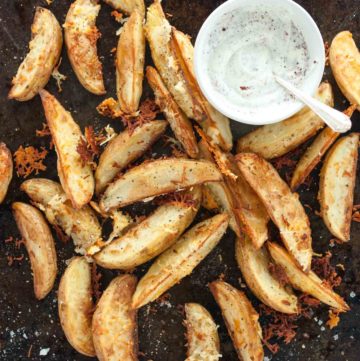 Caramelised halloumi potato wedges from How to Cook Halloumi cookbook by Nancy Anne Harbord. Baked potato wedges with crispy halloumi coating and sumac yoghurt dip. By @deliciouscratch | deliciousfromscratch.com