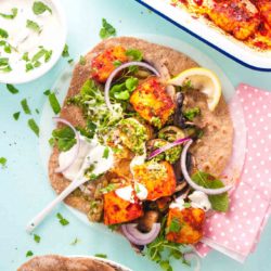Harissa halloumi kebabs recipe with spelt wraps from How to Cook Halloumi cookbook by Nancy Anne Harbord. Chunks of halloumi roasted with harissa chilli sauce. Pile onto whole grain wraps with sautéed vegetables, herbs and yoghurt for an easy vegetarian dinner. By @deliciouscratch | deliciousfromscratch.com