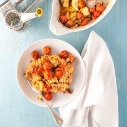 Tomato risotto with roasted halloumi recipe from How to Cook Halloumi cookbook by Nancy Anne Harbord. A scrumptious vegetarian risotto recipe flavoured with sun-dried tomato paste and topped with toasted halloumi, cherry tomatoes and garlic cloves. A delicious vegetarian main course. By @deliciouscratch | deliciousfromscratch.com