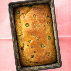 Halloumi cornbread recipe with tomato and chilli from How to Cook Halloumi cookbook by Nancy Anne Harbord. Moist, creamy cornbread stuffed with halloumi cheese, tomato and green chilli. An easy quick bread recipe that tastes amazing! By @deliciouscratch | deliciousfromscratch.com