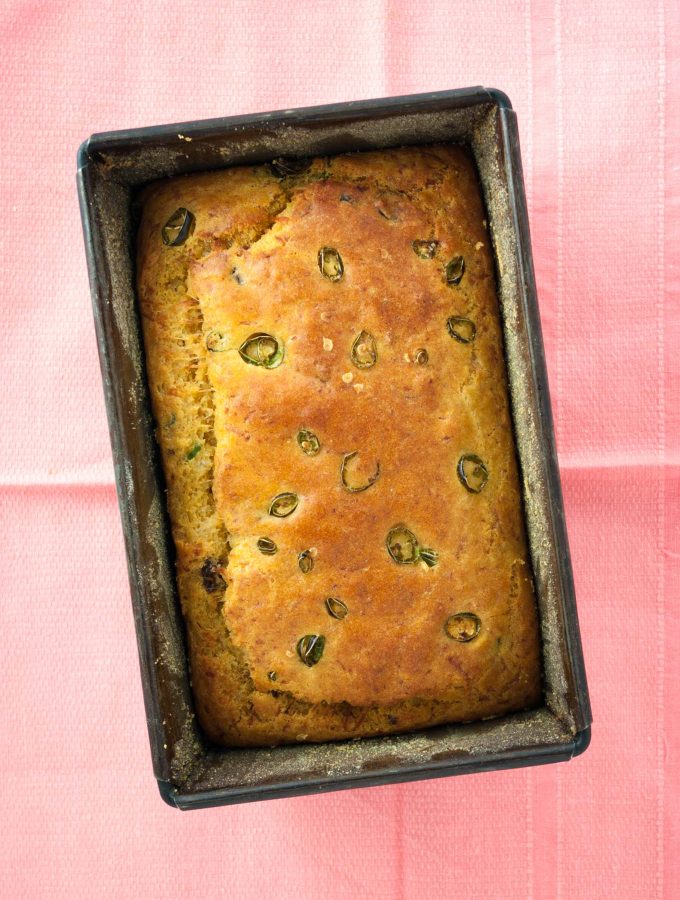 Halloumi cornbread recipe with tomato and chilli from How to Cook Halloumi cookbook by Nancy Anne Harbord. Moist, creamy cornbread stuffed with halloumi cheese, tomato and green chilli. An easy quick bread recipe that tastes amazing! By @deliciouscratch | deliciousfromscratch.com