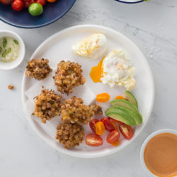 Vegetarian brunch with zing recipe – crispy Thai corn cakes, deep-fried eggs, fresh tomato salsa and greens