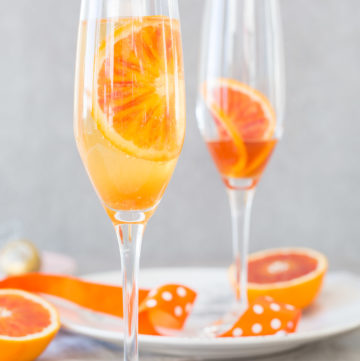 Blood orange fizz cocktail recipe – blood orange syrup, fresh blood oranges and sparkling white wine. The perfect spring cocktail!