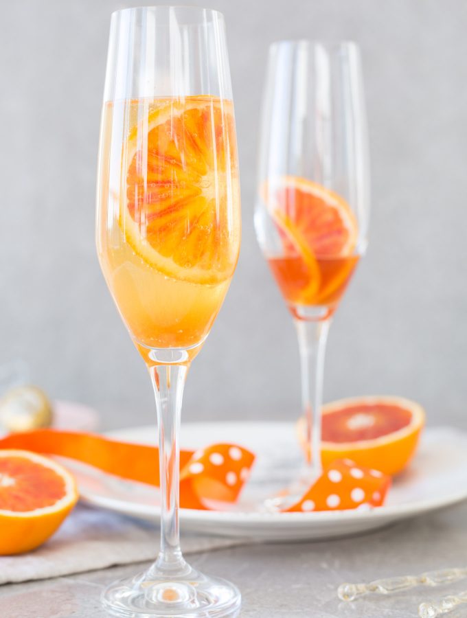 Blood orange fizz cocktail recipe – blood orange syrup, fresh blood oranges and sparkling white wine. The perfect spring cocktail!