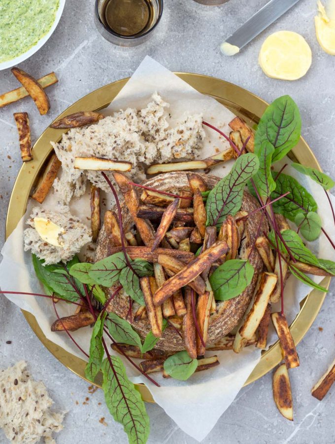 This epic sandwich is made from a whole sourdough loaf, stuffed with crispy oven chips and served with all kinds of sprinkles and dips. A brilliant meal to share.