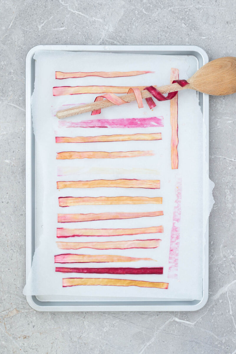 A simple, strikingly beautiful rhubarb garnish for cakes, desserts and cocktails. Just soak strips of rhubarb in sugar syrup and dry out in the oven.