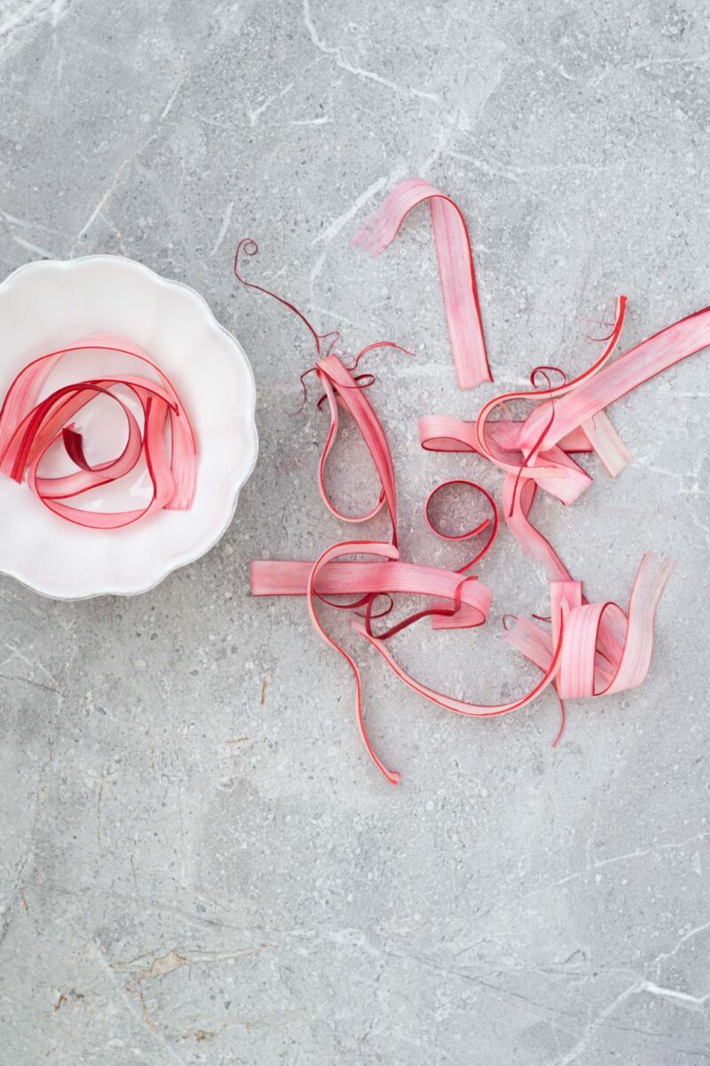 A simple, strikingly beautiful rhubarb garnish for cakes, desserts and cocktails. Just soak strips of rhubarb in sugar syrup and dry out in the oven.